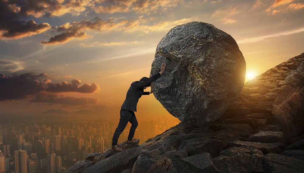 Business man pushing large stone up to hill , business heavy tas
